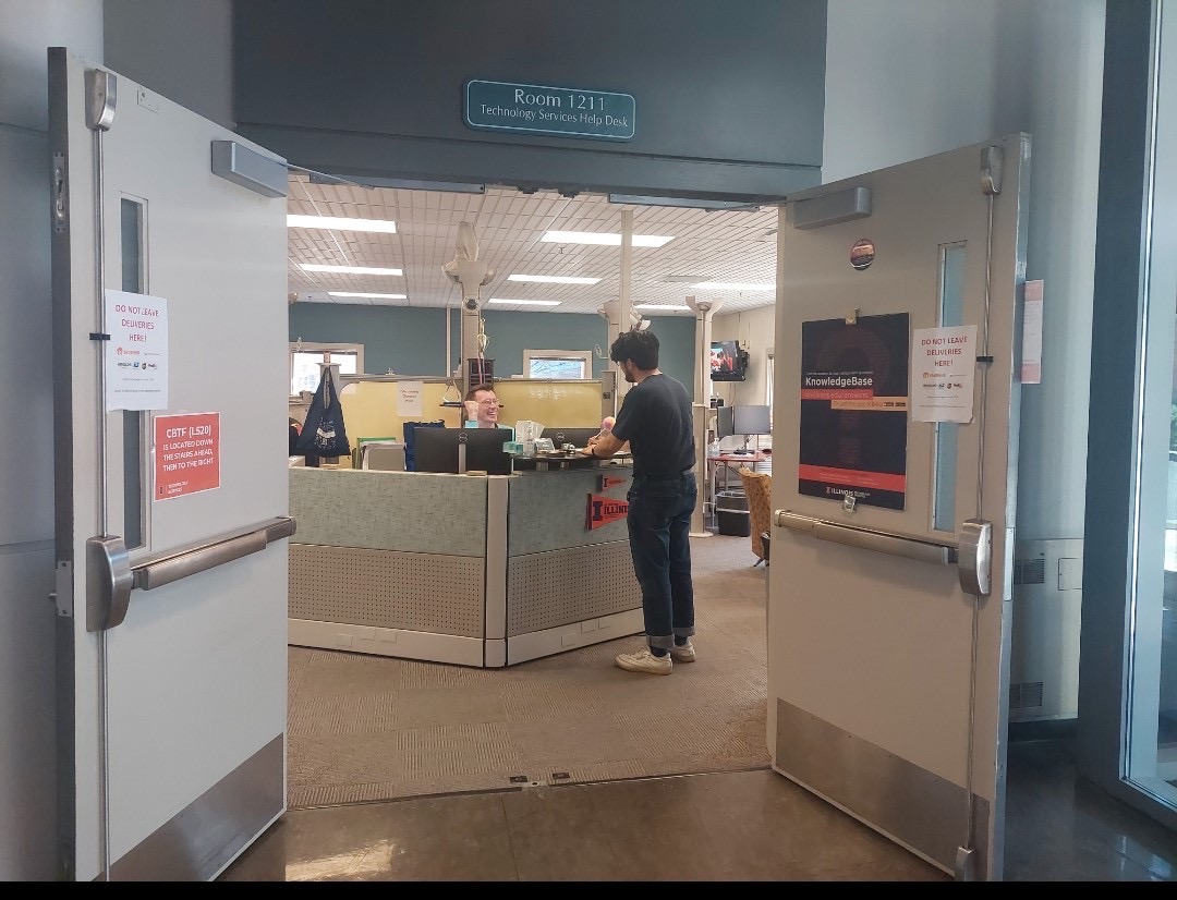 Student standing at the Tech Services Help Desk at DCL