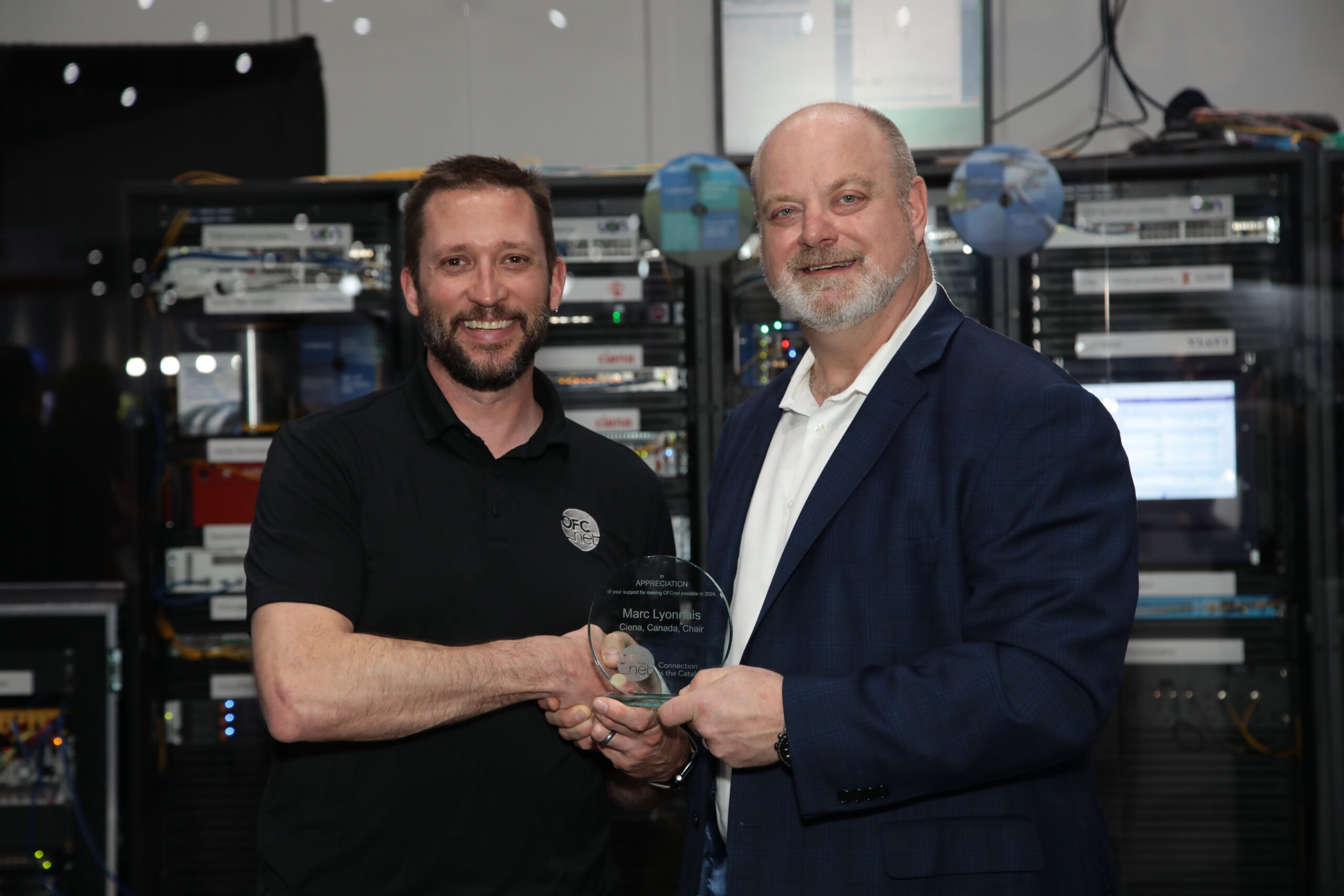 Chris Skaar receiving recognition for supporting the OFC conference