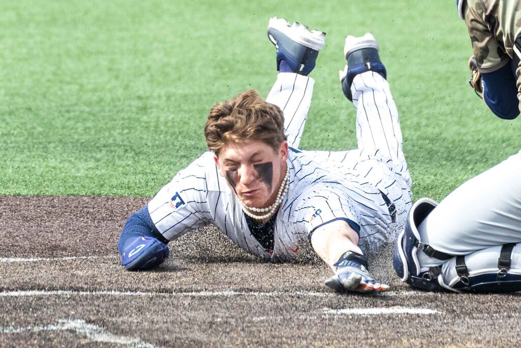 Coltin Quagliano slides safely into home at an Illini game on March 30, 2024
