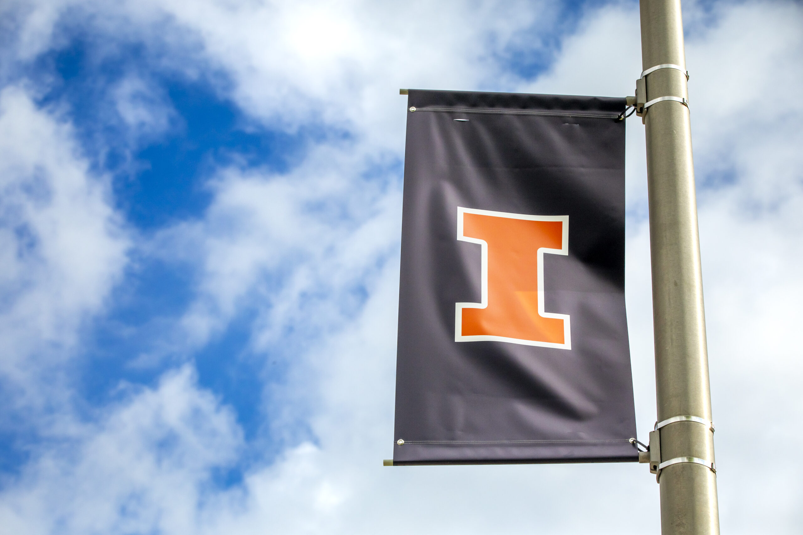 Orange block I on a blue banner on a light pole