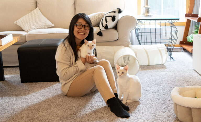 Kate Sammons with her two kittens in her home.