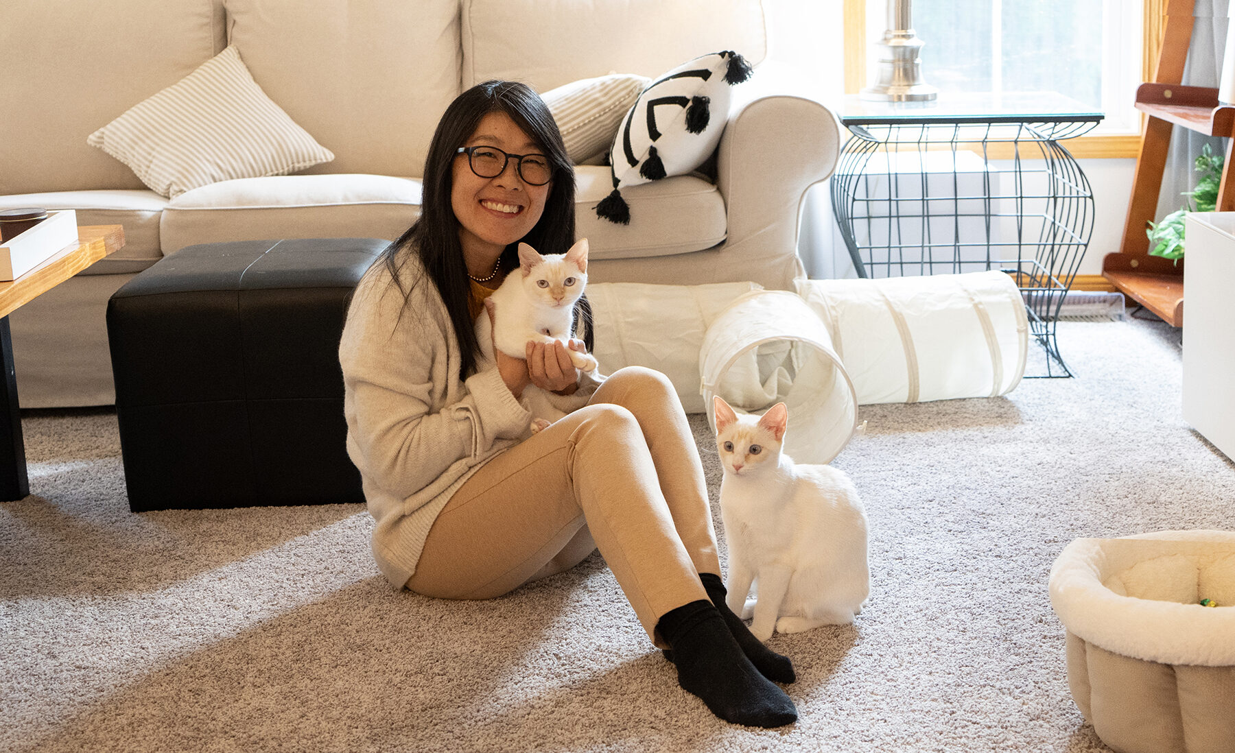 Kate Sammons with her two kittens in her home.